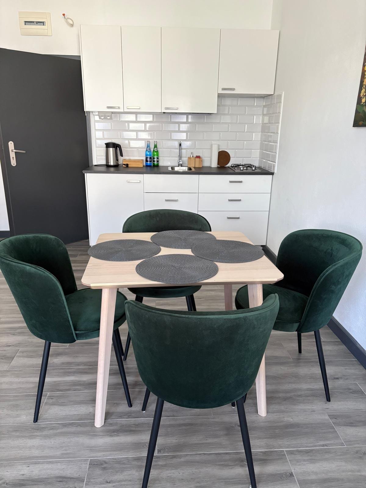 Apartament nr 4 — część jadalniana z zielonymi krzesłami, Willa Pod Platanem Bytów